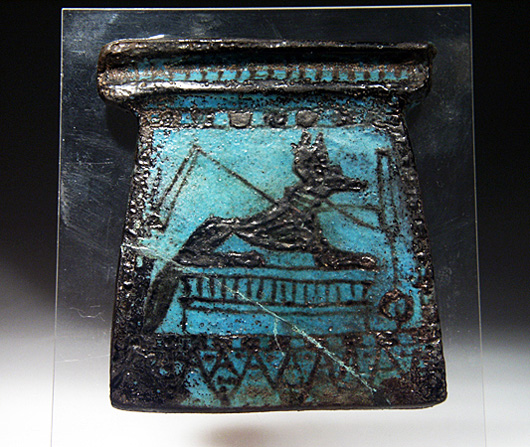 Pectorals placed around the neck of mummies were usually decorated with images of funerary gods and regeneration symbols, as is the case on this specimen of glazed faience. This New Kingdom or shortly later piece is about 3 1/2 inches high. It has a $7,000-$8,000 estimate. Image courtesy of Artemis Gallery Live.com.
